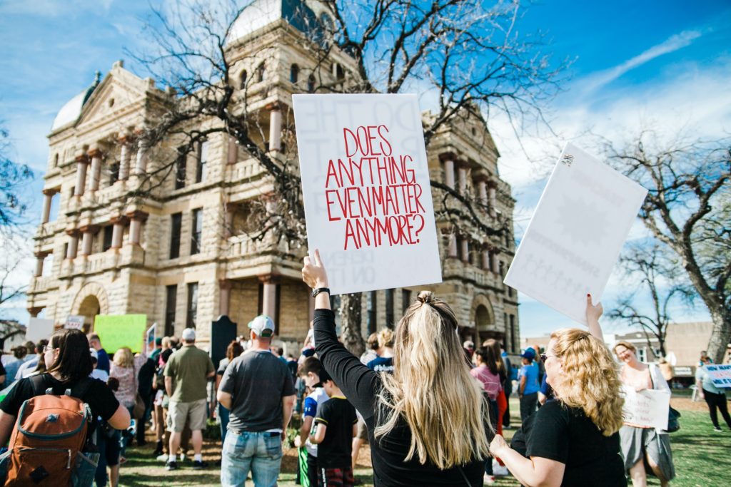Protest with sign writing prompt photo